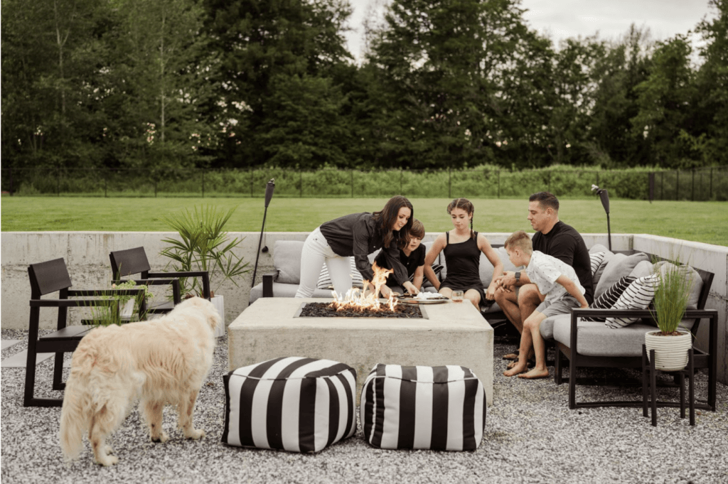 a family enjoying s'mores around the fire pit
