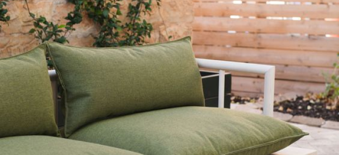 Green cushions on a white metal sofa.
