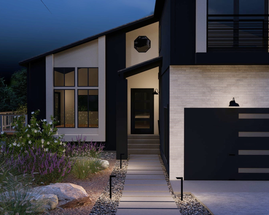 Front yard design night view with lights illuminated on garage and home exterior