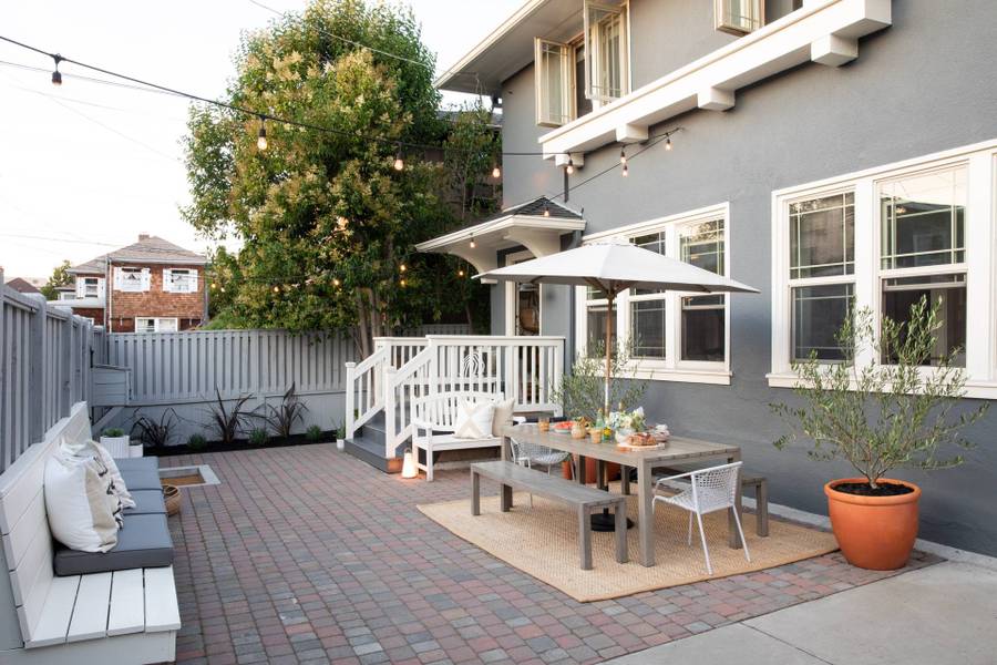 small paved backyard with outdoor dining area