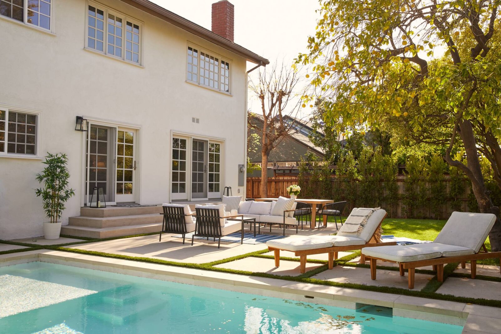Los Angeles backyard with pool, lounge chairs, and dining area