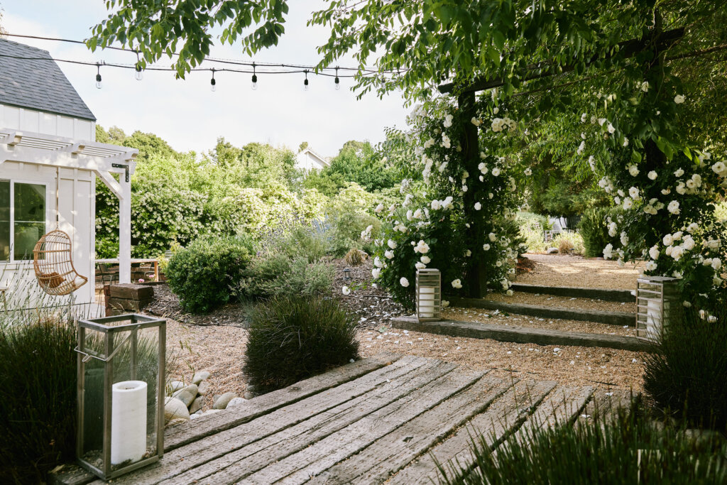 cottage-inspired backyard with a wood deck and pea gravel