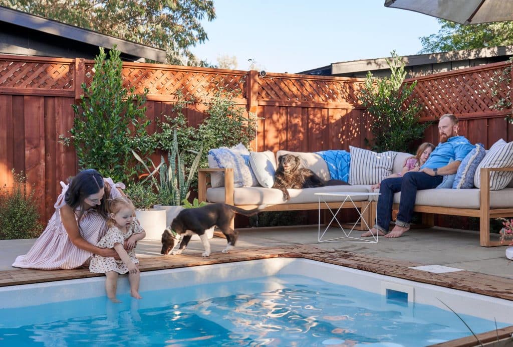 Family and dogs enjoying plunge pool in backyard