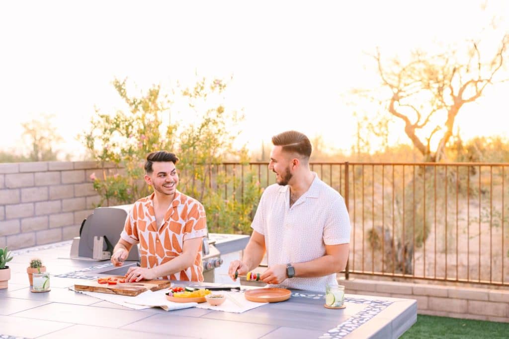 Couple preparing meal outside near bbq