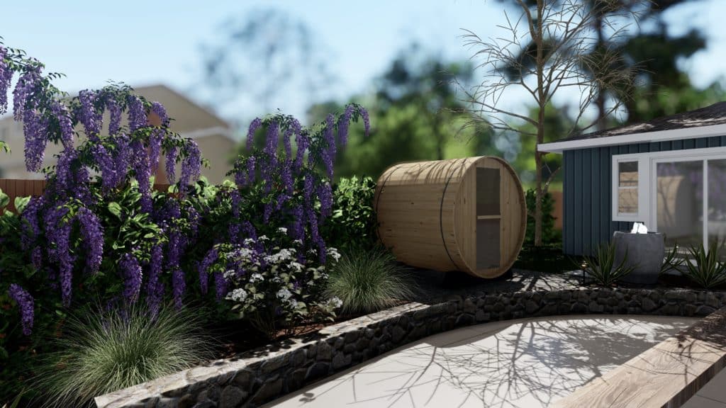 Barrel Sauna above stone retaining wall between a backyard ADU and colorful planting bed.