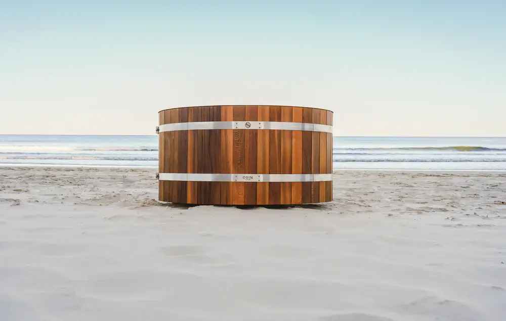 Cedar tub with metal supports on a beach.